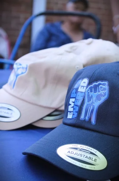 Navy and white Empowered event caps designed by Surge for AJEC Youth