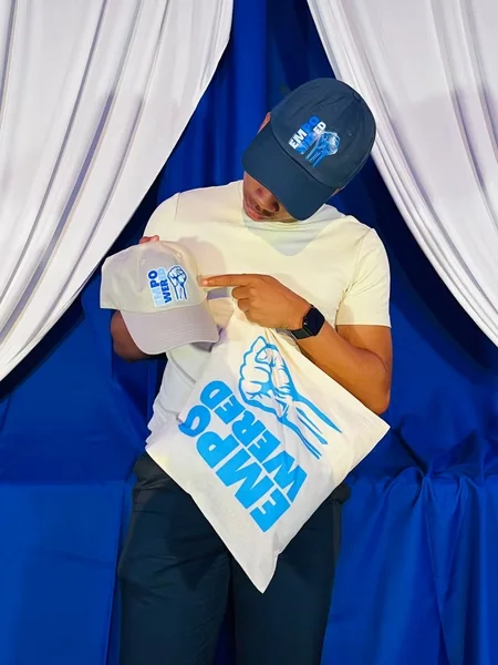 Person holding the Empowered event tote bag designed by Surge