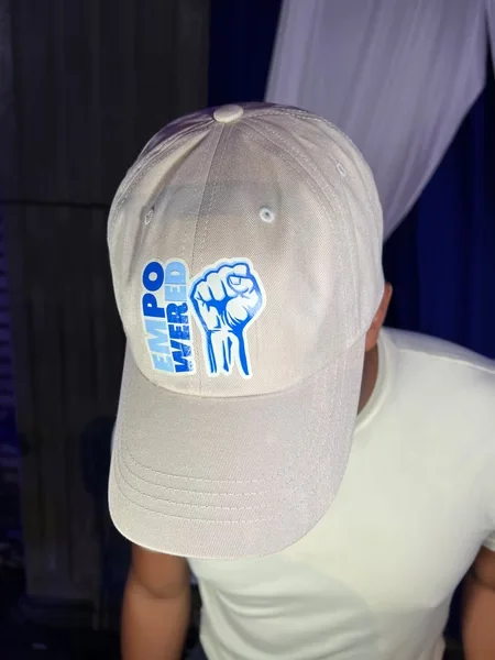 White Empowered event cap designed by Surge