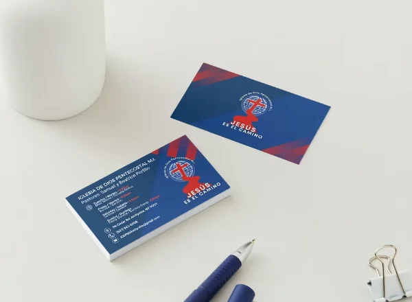 Jesús es el Camino business cards on a desk, designed by Surge